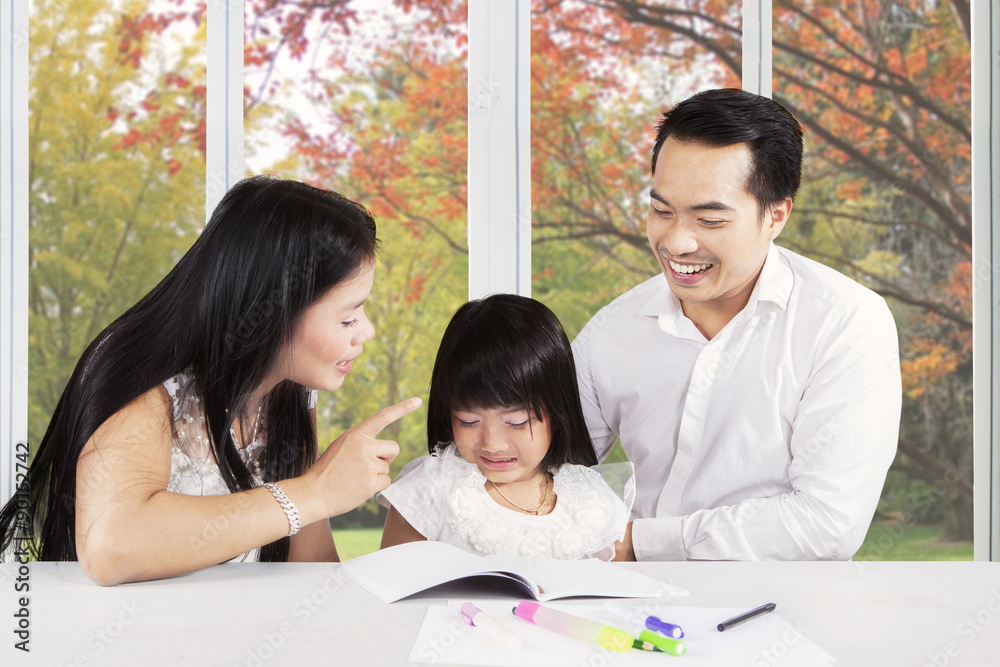 Father and mother advising their kid to learn Father and mother advising their kid to learn