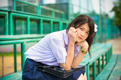 Shy Asian schoolgirl student in high school uniform showing facial bashful expression