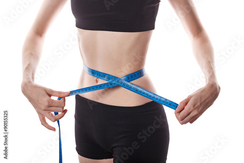 Girl measures the waist. Weight loss.