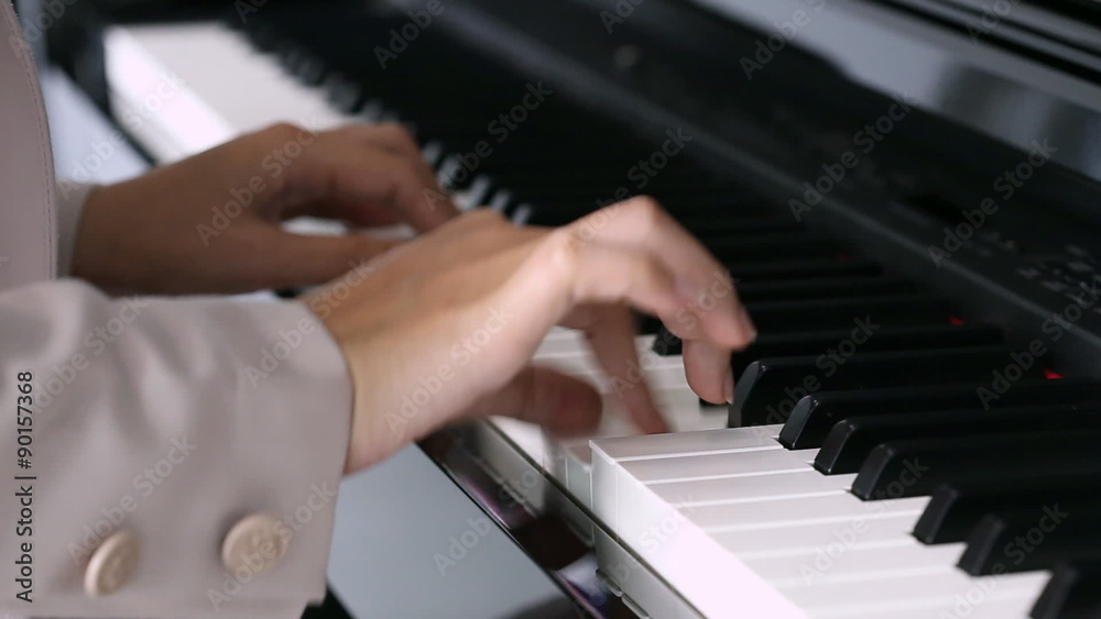 Close up of the hands of a young woman playing piano Close up of the hands of a young woman playing piano