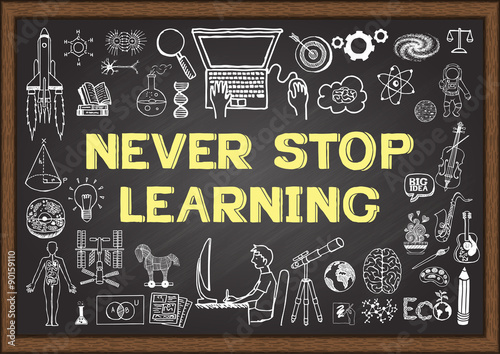 Business and education doodles with the concept of NEVER STOP LEARNING on chalkboard.
