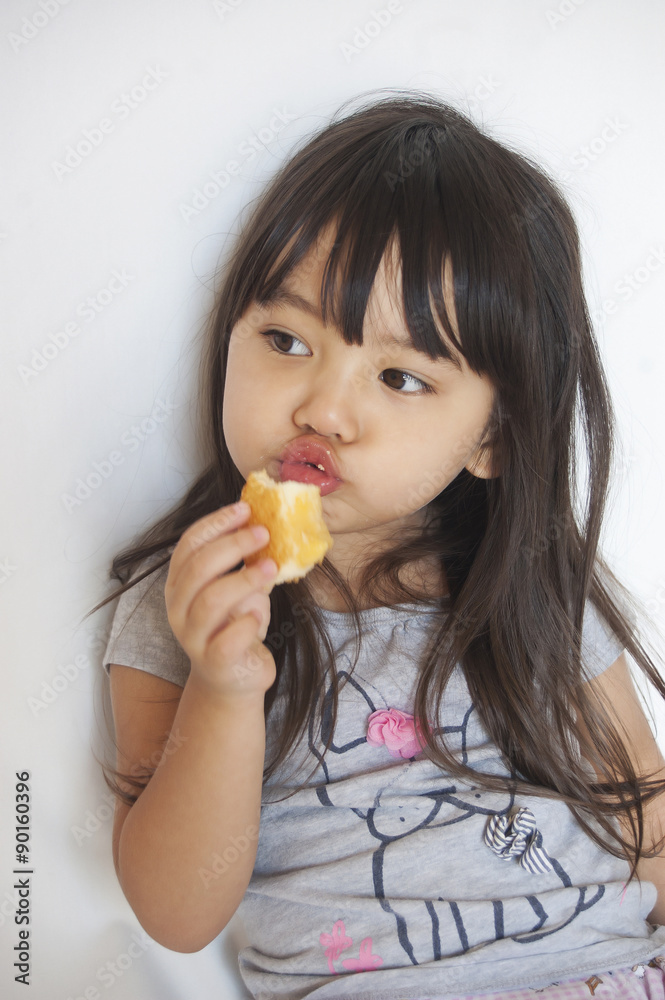 a little girl enjoys her custard cake a little girl enjoys her custard cake