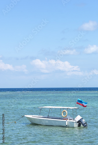 Boat with clean water and blue skies