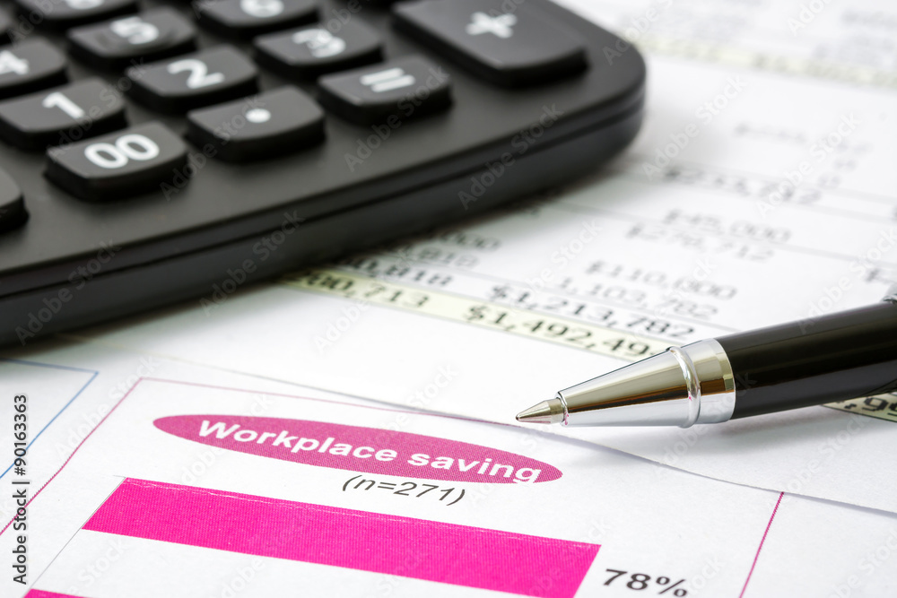 Black pen with financial report and calculator Black pen with financial report and calculator