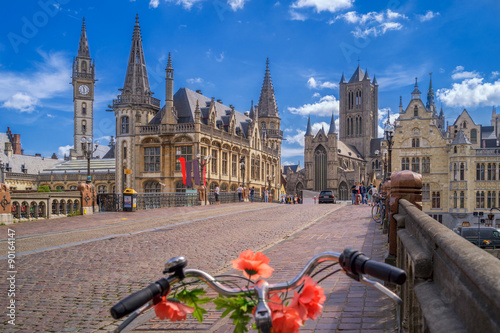 Blue sky over Gent, Belgium, with a traditionally decorated bicycle in the foreground photo