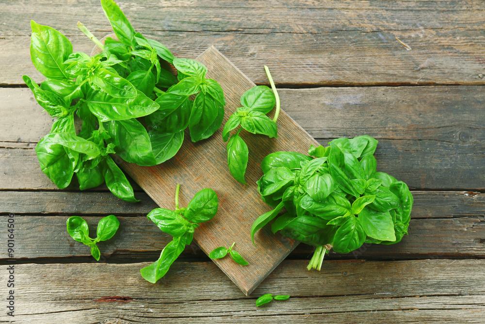Green fresh basil on wooden background Green fresh basil on wooden background