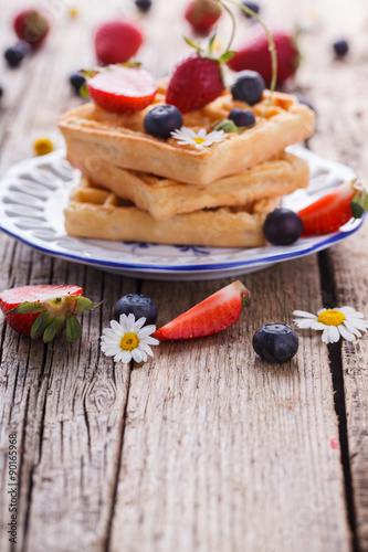 Waffles with strawberries and blueberries for Breakfast,Belgian.Copy space. selective focus