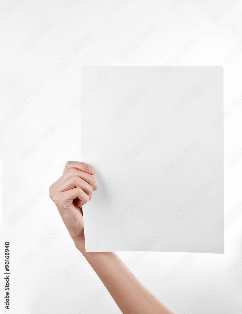 Foto de Female hand holding paper blank isolated on white do Stock | Adobe  Stock