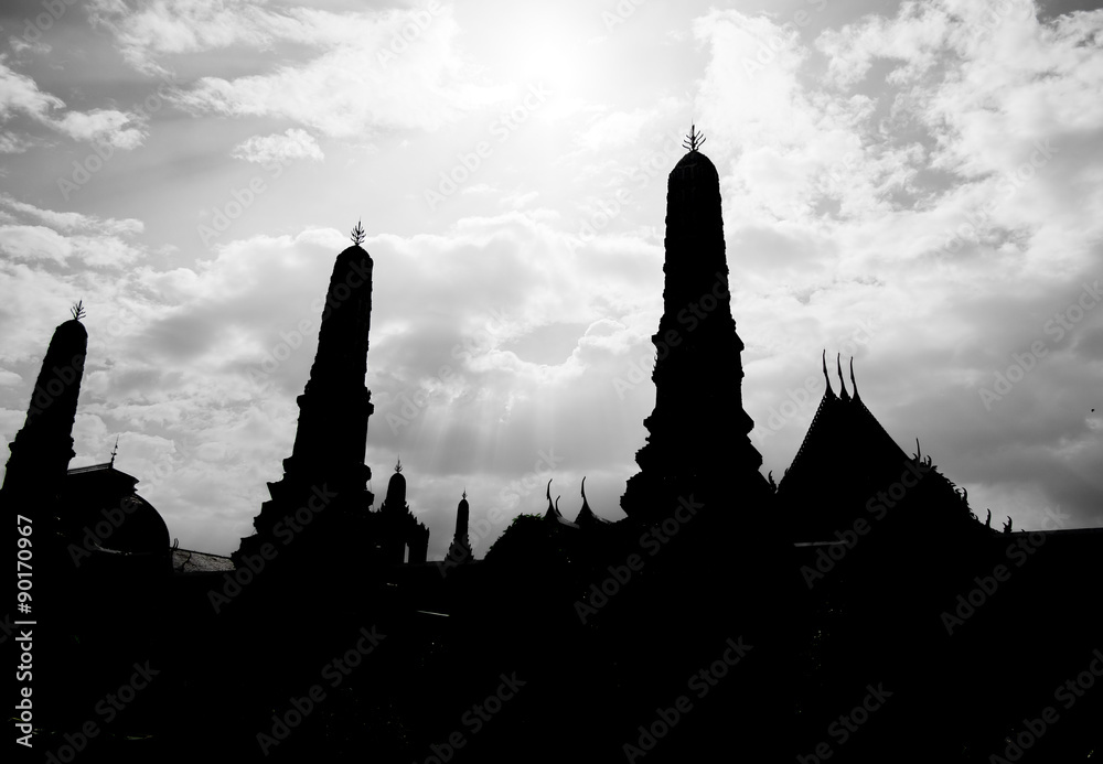 silhouette photo of Thai pagoda with sun beam,sky and cloud