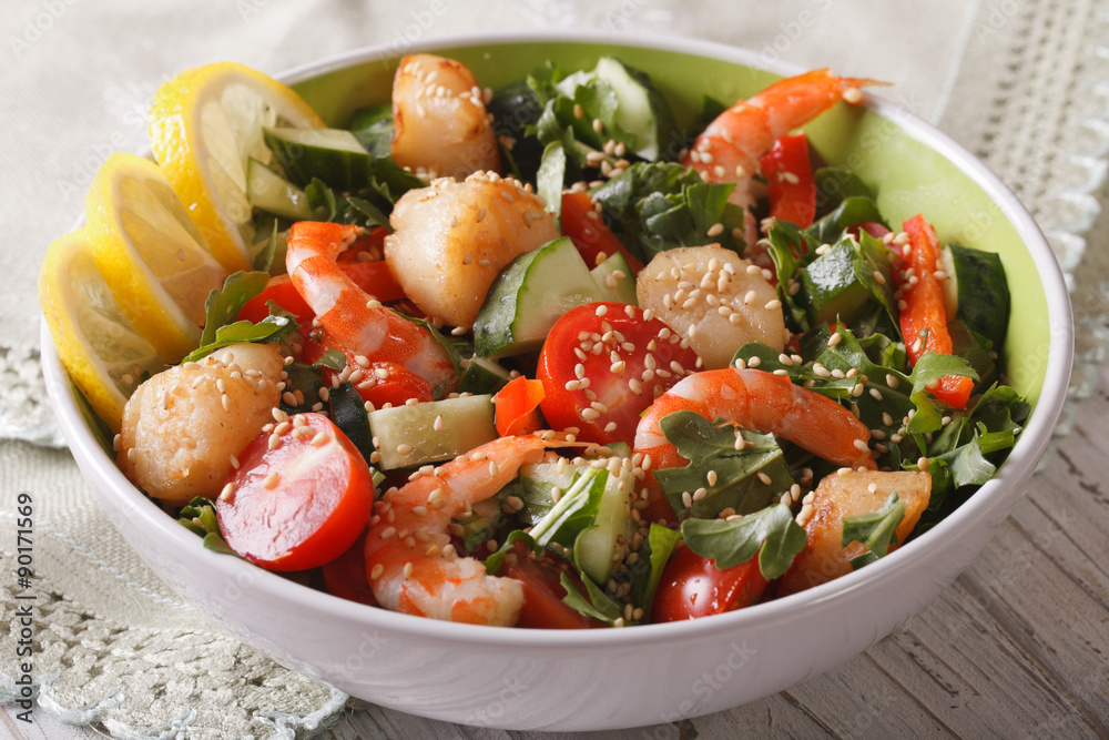 Fresh salad with seafood and vegetables in a bowl closeup.
Fresh salad with seafood and vegetables in a bowl closeup.