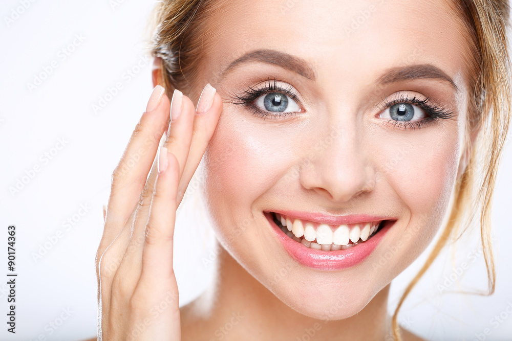 Young woman touching her face isolated on white background Young woman touching her face isolated on white background
