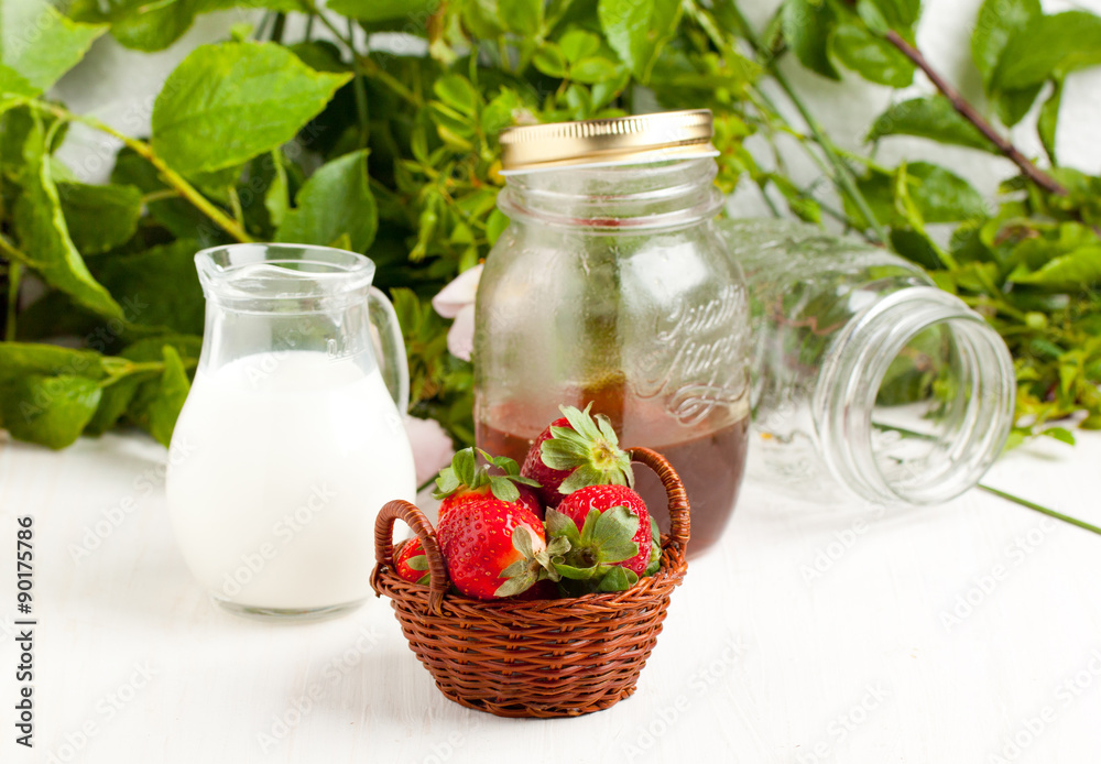 Basket of fresh strawberries with milk and honey Basket of fresh strawberries with milk and honey