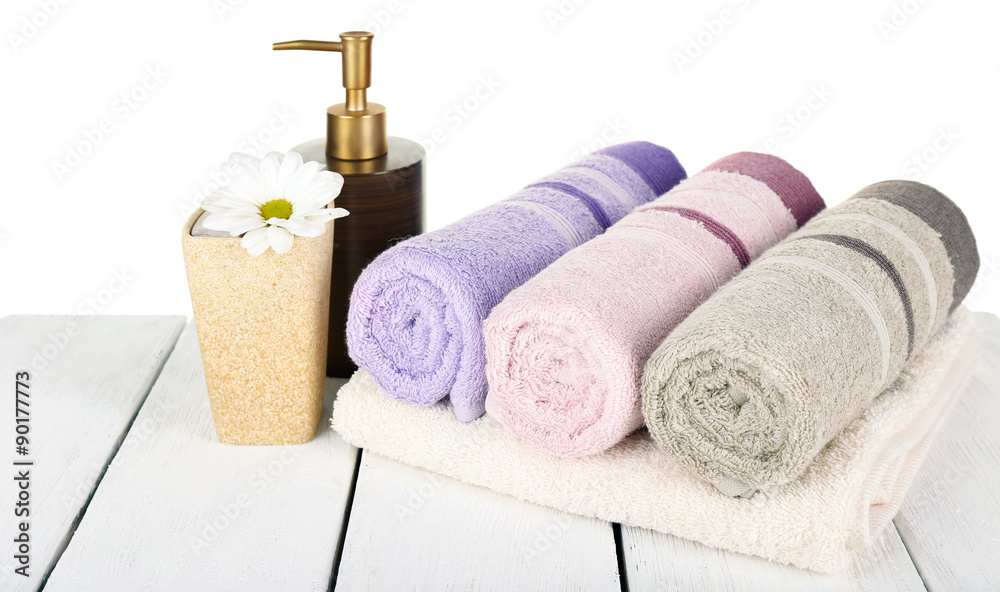 Soft towels with dispenser and flower isolated on white Soft towels with dispenser and flower isolated on white