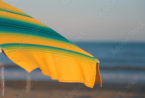 green and yellow umbrella on the sunny beach in summer © ChiccoDodiFC