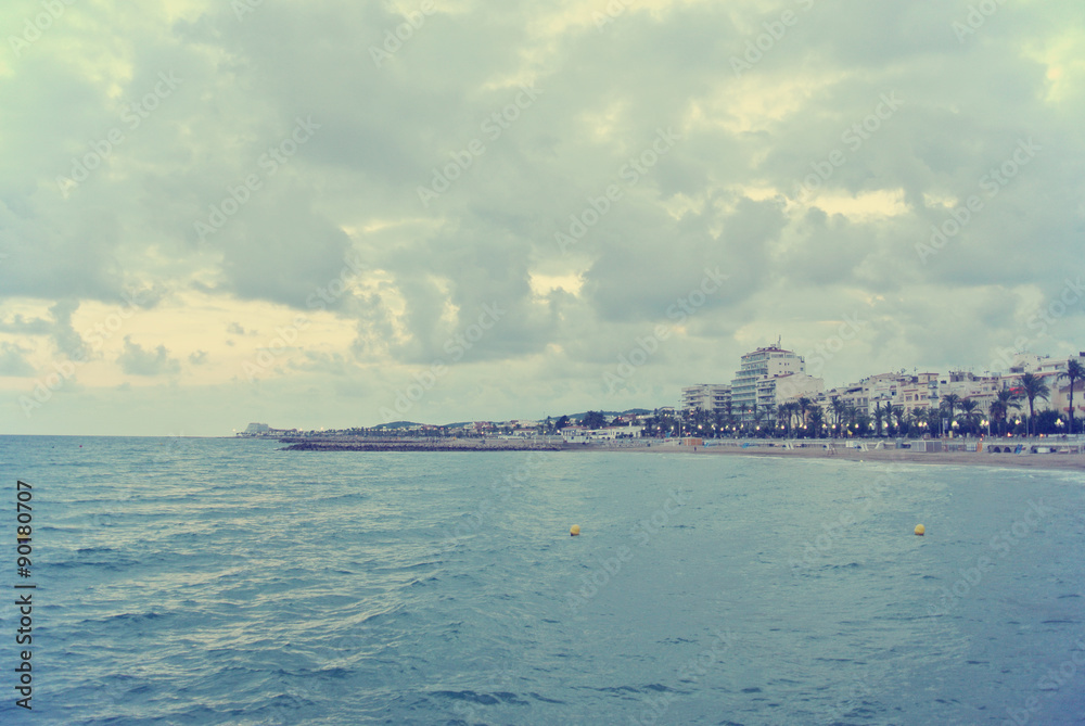 Seaside landscape on a cloudy, windy afternoon in early autumn. Image filtered in faded, washed out, retro, Instagram style; nostalgic, vintage 