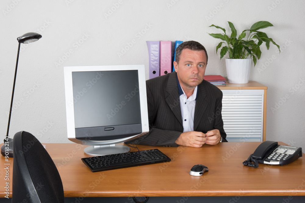 Middle age businessman working on laptop computer afraid to meet recruiter Middle age businessman working on laptop computer afraid to meet recruiter
