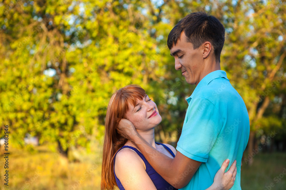 Young couple hugging in forest outdoors Young couple hugging in forest outdoors
