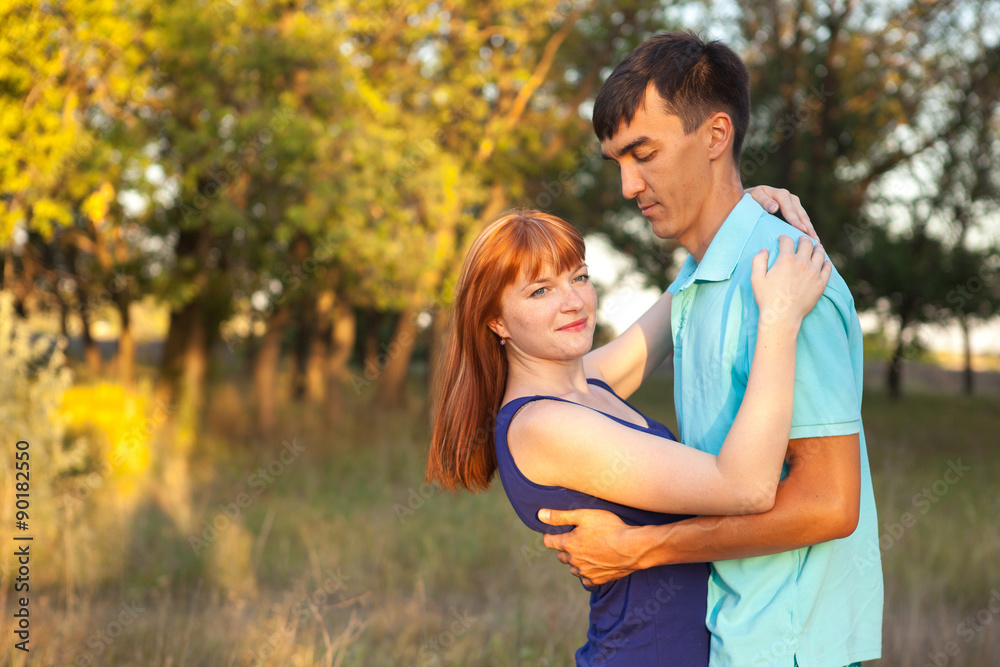 Obraz premium Young couple hugging in forest outdoors