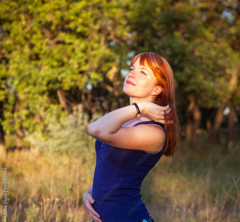 Beautiful red-haired girl posing in the outdoors Beautiful red-haired girl posing in the outdoors