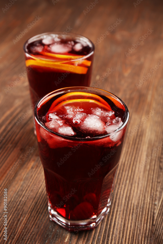 Glasses of cherry juice on wooden background Glasses of cherry juice on wooden background