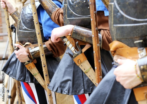 medieval soldiers with hands on the sheath knife