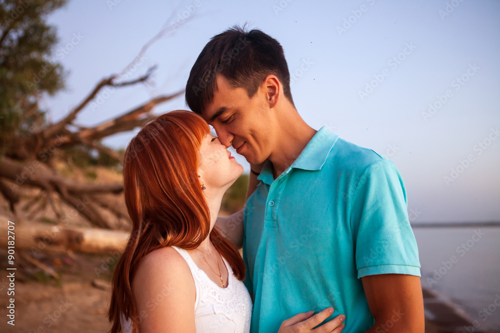Fototapeta premium young couple looking in one direction, the distance in the park,