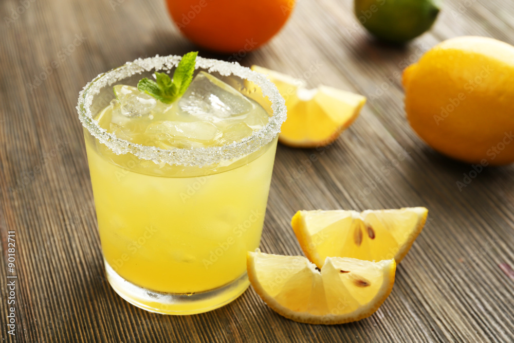 Glass of lemon juice on wooden table, closeup Glass of lemon juice on wooden table, closeup