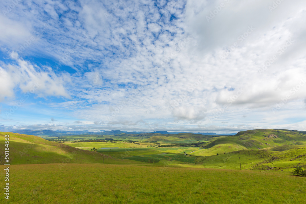 Thin clouds over green valley