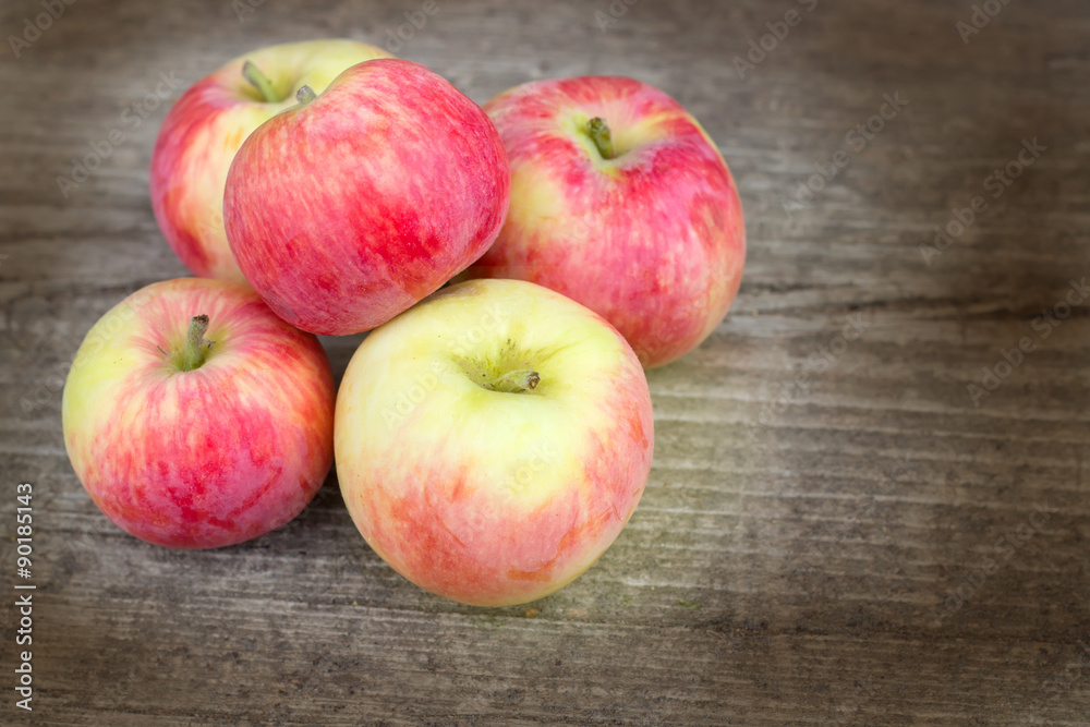 Small group of fresh natural apples on wooden texture Small group of fresh natural apples on wooden texture
