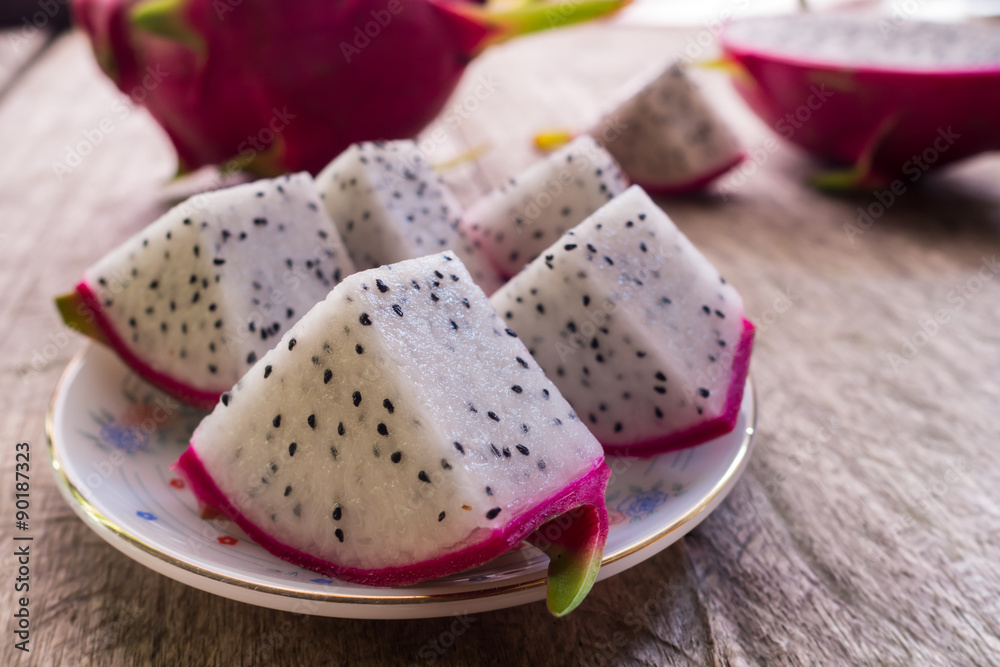 Dragon Fruit and some slice on old Wooden Table Dragon Fruit and some slice on old Wooden Table