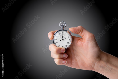 timer hold in hand, button pressed black/grey background