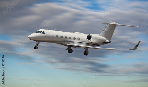 Side view of a private jet flying