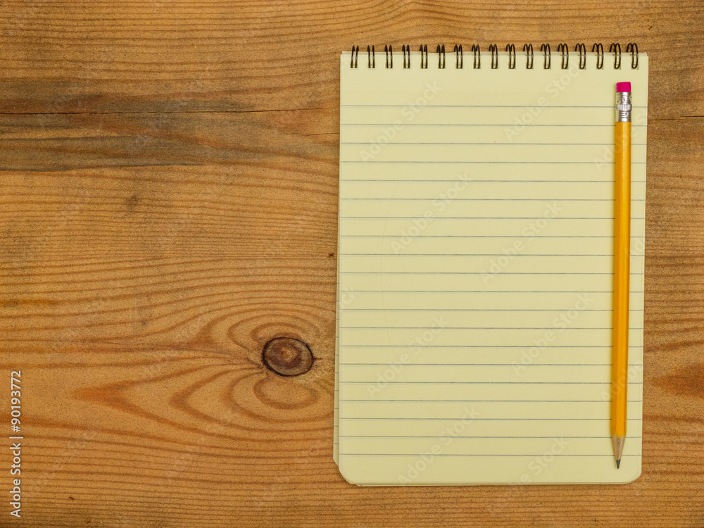 Notebook and pencil on wooden board Notebook and pencil on wooden board