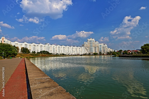 Residential white apartment house on the banks of the narrow river