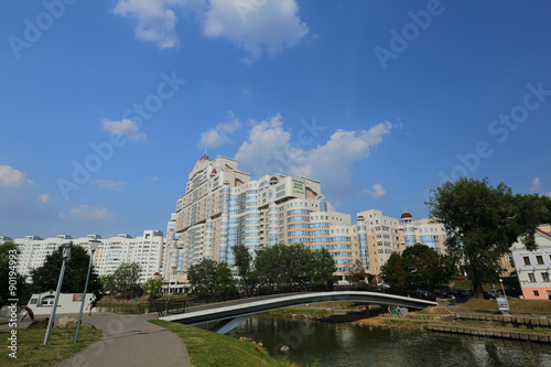 Residential white apartment house on the banks of the narrow river