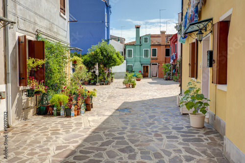 Small square with colorful houses in Burano island, Venice, Italy