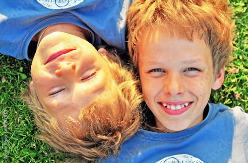 Boys luying on the grass photo