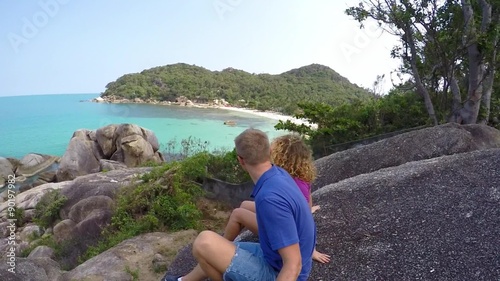 Couple Watching the Sea from the Mountain. Slow Motion. photo