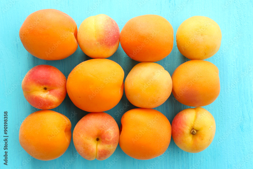 Ripe apricots on wooden table close up