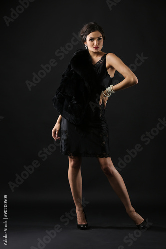 Retro style photo on pretty woman on dark background