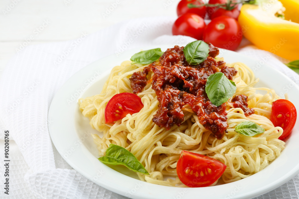 Spaghetti Bolognese on white plate, on color wooden background Spaghetti Bolognese on white plate, on color wooden background