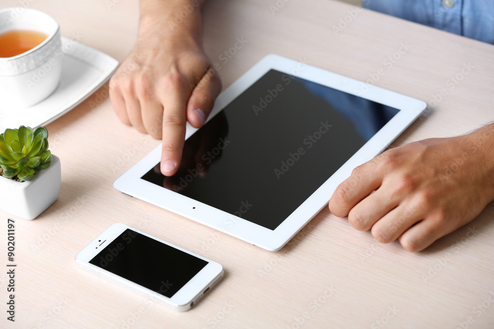 Man with digital tablet on wooden table background