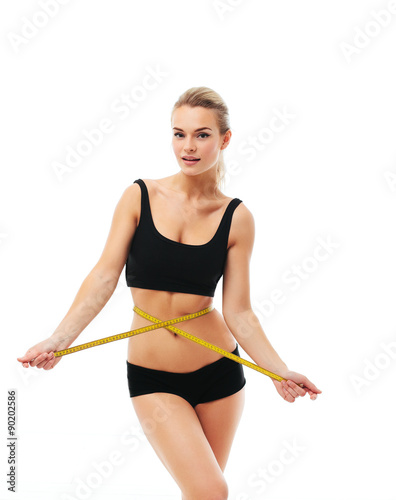 sporty woman and measure around her body on white background