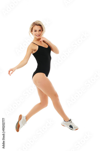Fototapeta Naklejka Na Ścianę i Meble -  Fitness healthy women jumping in studio isolated