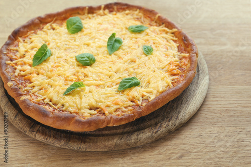 Cheese pizza with basil on table close up
