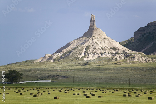 Fotografie Hay bails in front of Chimney Rock National Historic Site, Nebraska, the most fa