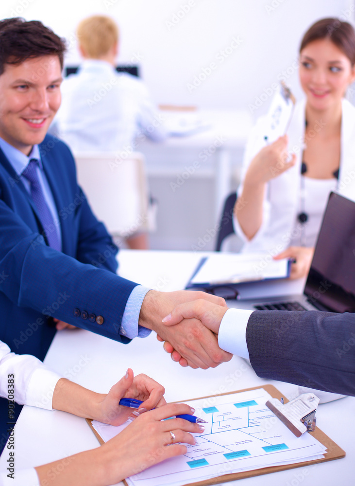Business people shaking hands, finishing up a meeting, in office Business people shaking hands, finishing up a meeting, in office