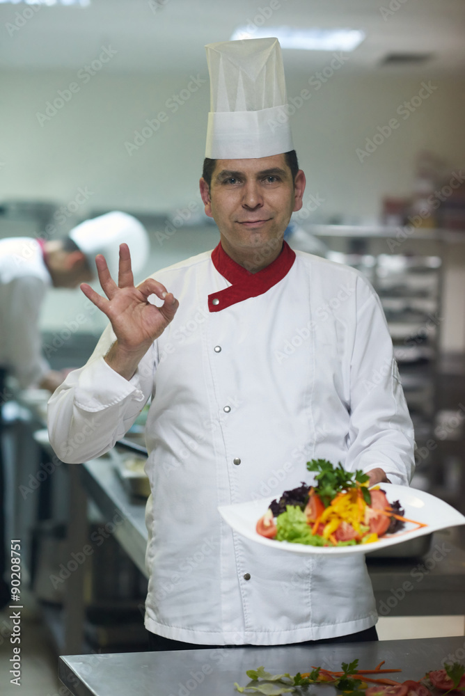 chef in hotel kitchen preparing and decorating food chef in hotel kitchen preparing and decorating food