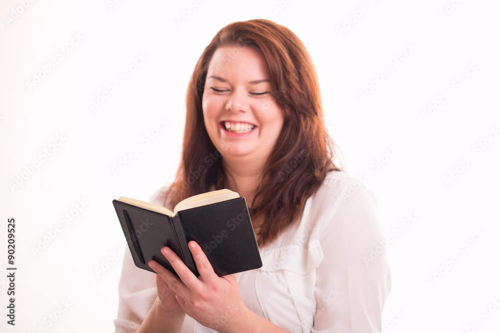 Happy woman reads smal notebook Happy woman reads smal notebook