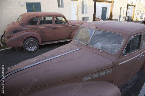 Vintage rusty 1940s car parked in front of Route 66 Motel, Barstow California photo